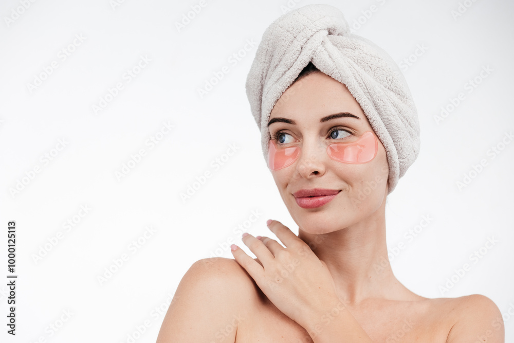 Eye patches, patch under eyes. smiling young girl has collagen golden eye patches on face with towel. Beautiful woman isolated face portrait, banner with mock up copy space Eye patches, patch under eyes. smiling young girl has collagen golden eye patches on face with towel. Beautiful woman isolated face portrait, banner with mock up copy space