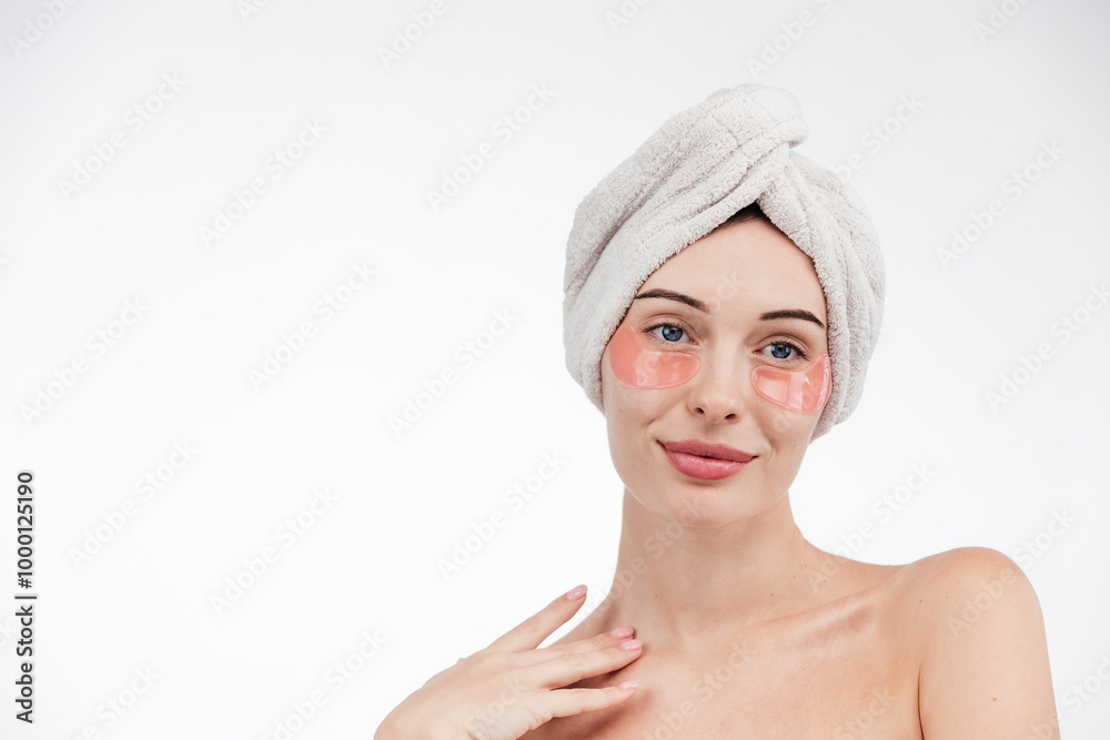 Eye patches, patch under eyes. smiling young girl has collagen golden eye patches on face with towel. Beautiful woman isolated face portrait, banner with mock up copy space Eye patches, patch under eyes. smiling young girl has collagen golden eye patches on face with towel. Beautiful woman isolated face portrait, banner with mock up copy space