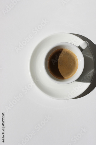 Freshly Made Espresso Shot with Crema Foam on White Background. Drinking Morning Coffee.