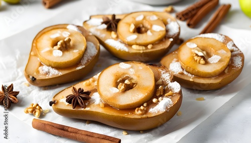 Gourmet baked pears garnished with nuts and anise stars on a pristine white table photo