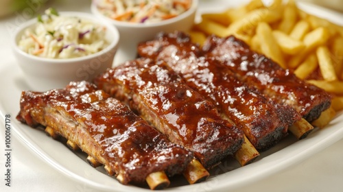 A delicious platter of fried pork ribs with a side of fries and coleslaw, beautifully arranged on a white tablecloth, inviting diners to enjoy a hearty meal.