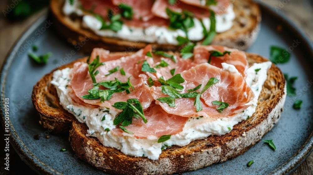 Open-face sandwich with finely sliced ham and a spread of cream cheese, garnished with chopped herbs on crusty bread, perfect for a tasty meal or snack. Open-face sandwich with finely sliced ham and a spread of cream cheese, garnished with chopped herbs on crusty bread, perfect for a tasty meal or snack.