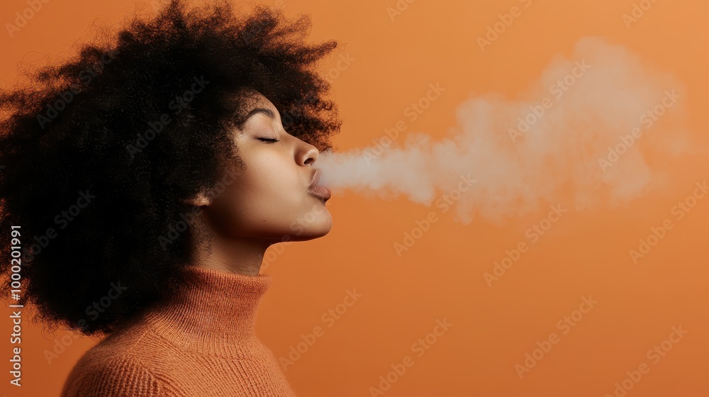 A creative and stylish perspective of a person exhaling a vapor stream against a plain orange background, evoking modernity and encapsulating urban artistic trends.