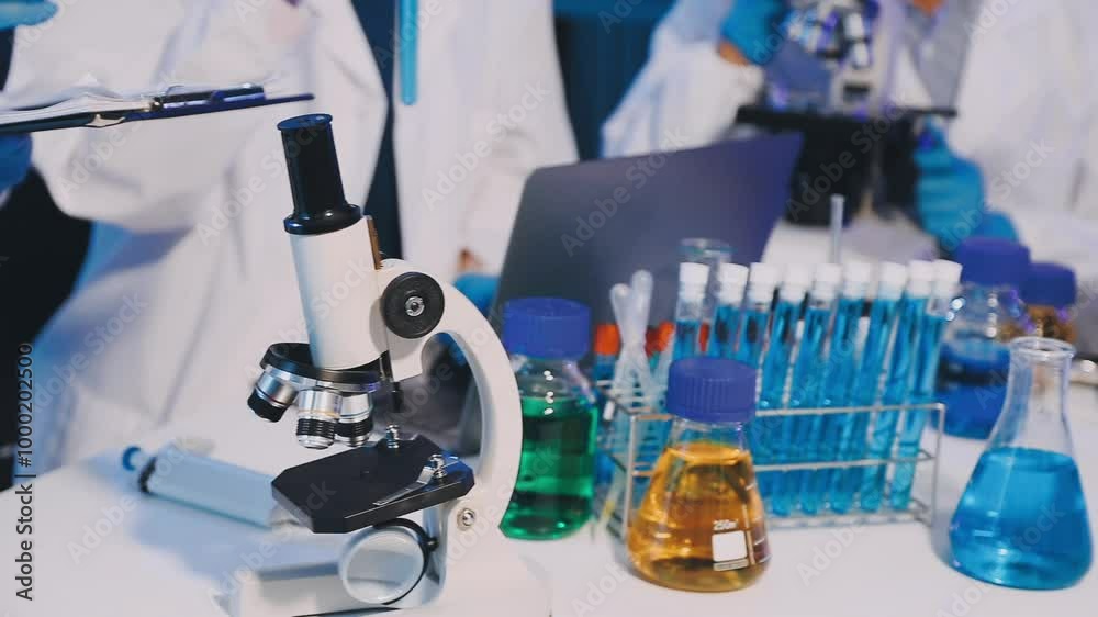 Medical development research laboratory, chemist or science scientist student hand in glove, drop water into pipette for test analysis liquid sample in clinic lab. Microbiology, analysing for medicine Medical development research laboratory, chemist or science scientist student hand in glove, drop water into pipette for test analysis liquid sample in clinic lab. Microbiology, analysing for medicine