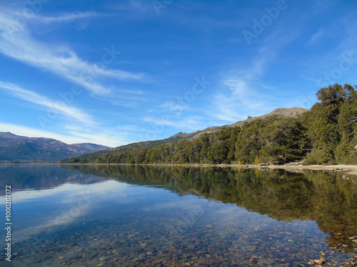 Idyllic view of Meliquina Lake with mountains reflecting in its crystal clear waters,