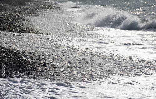 Backlit shore at Millook Haven Cornwall photo