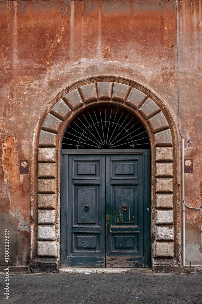 Interesting door on a building in Rome, Italy. Interesting door on a building in Rome, Italy.