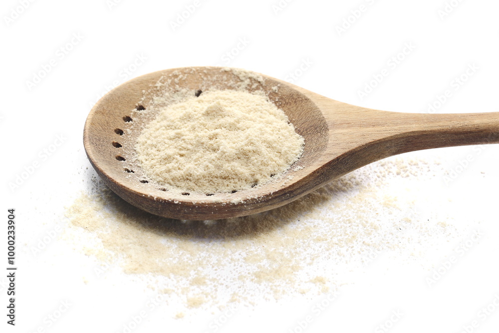 Sesame flour pile in wooden spoon isolated on white, side view Sesame flour pile in wooden spoon isolated on white, side view