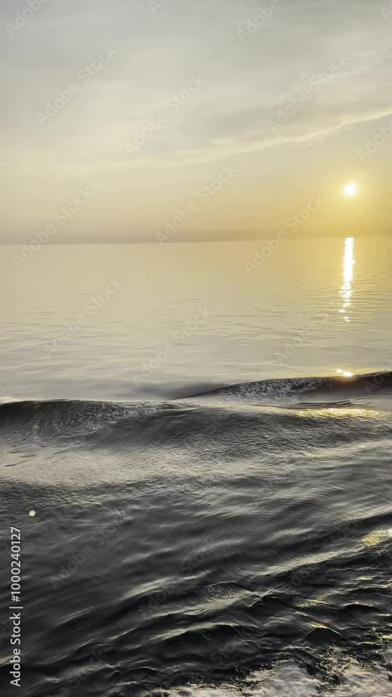Beautiful wave in calm seas with the sun setting Beautiful wave in calm seas with the sun setting