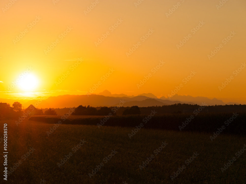 AERIAL, COPY SPACE: Scenic vista of a golden sunset gently illuminating the silhouettes of forest covered hills. Picturesque drone view of the vast countryside on a perfect autumn evening in Slovenia. AERIAL, COPY SPACE: Scenic vista of a golden sunset gently illuminating the silhouettes of forest covered hills. Picturesque drone view of the vast countryside on a perfect autumn evening in Slovenia.