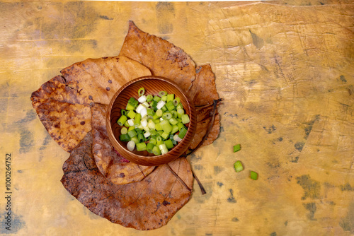 Wooden bowl with cut green onions