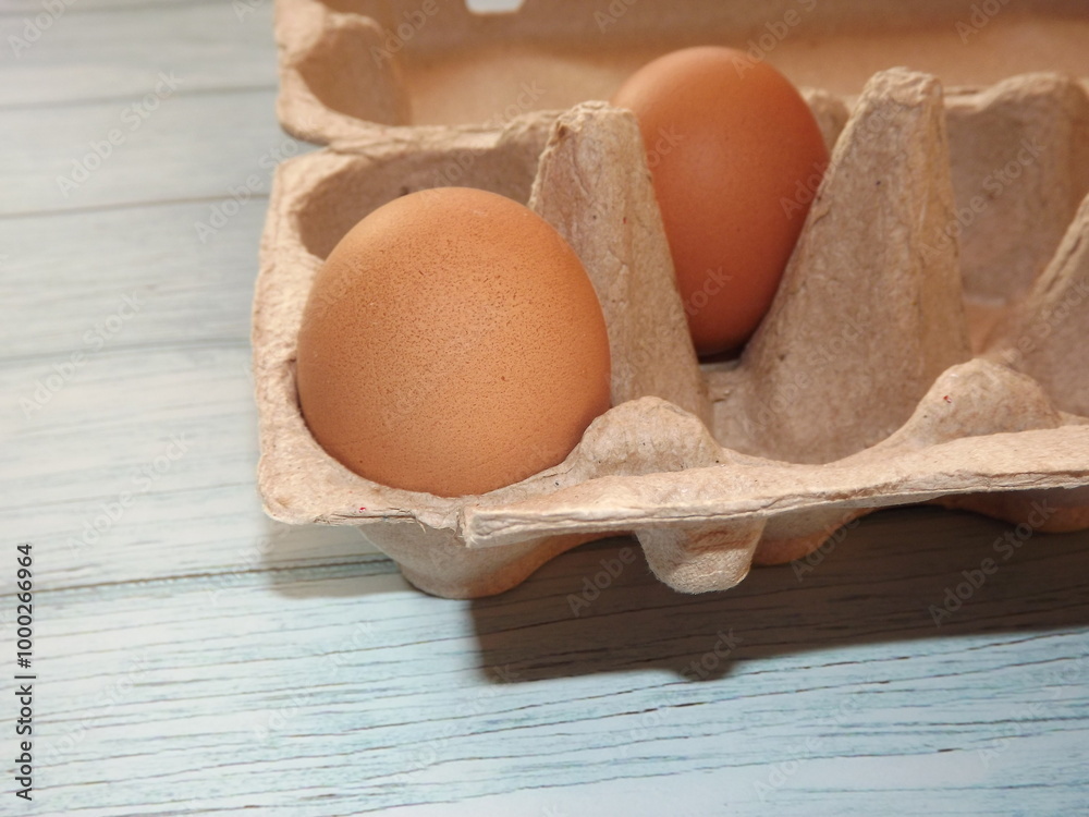 chicken eggs in an egg box on wooden background. High quality photo chicken eggs in an egg box on wooden background. High quality photo