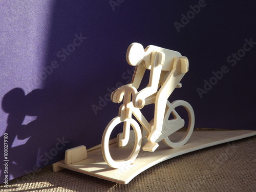 cyclist on a bicycle made of wood on a purple background. High quality photo photo