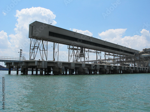 An industrial factory on the coast with a view of the clean ocean and pollution-free air, showcasing an eco-friendly environment