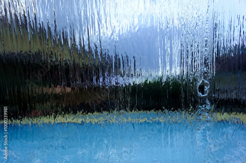 A fountain designed to resemble a waterfall, serving as a decorative feature for a family swimming pool