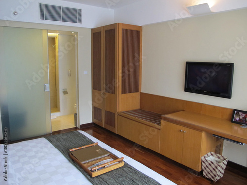 A hotel room interior with a minimalist design that offers comfort and tranquility, making it an ideal destination for a family vacation