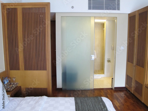 A hotel room interior with a minimalist design that offers comfort and tranquility, making it an ideal destination for a family vacation