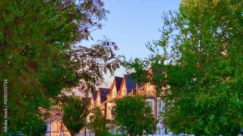 Traditional Brick Houses in North London architecture: A Daytime Street View Under a Blue Sky photo