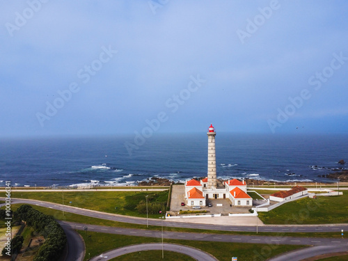 View of lighthouse Portuguese, with nice details and very particular framing, blue sky as background, located in Leça da Palmeira, Porto, Portugal. Matosinhos. Leça Beach. Drone. Aerial view photo