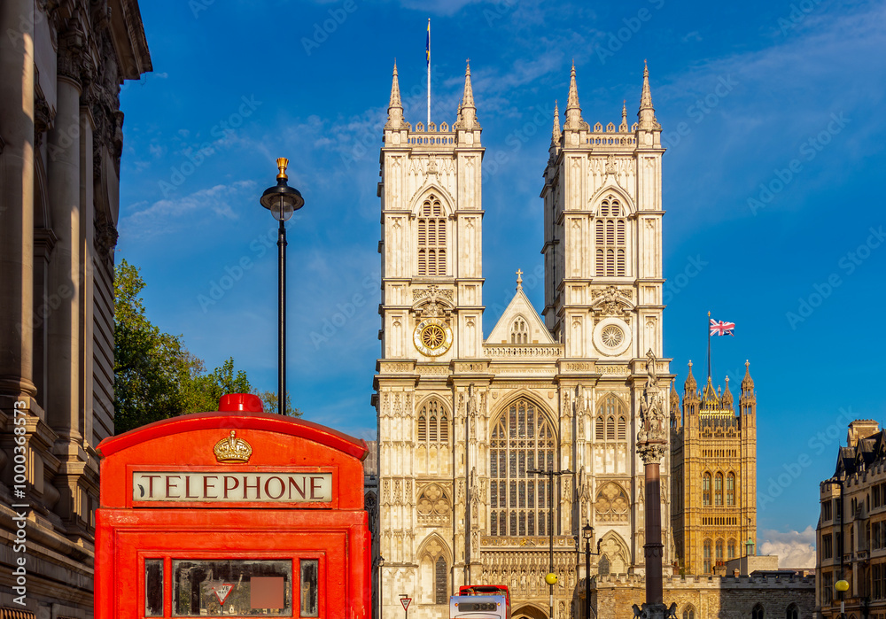 Obraz premium Westminster Abbey and red telephone box in London, UK