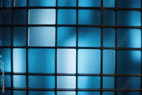 Image of a multicolored stained glass window with irregular block pattern in a hue of blue, square format