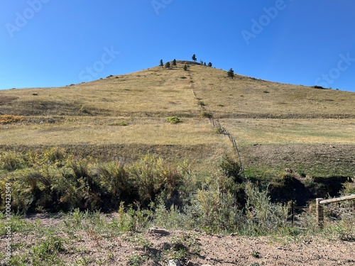 A small hill with a fence leading up to the top, Boulder, Colorado photo