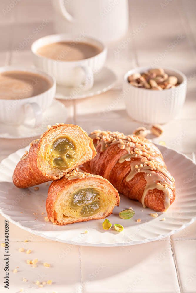 Delicious and sticky pistachio croissants served with hot coffee. Delicious and sticky pistachio croissants served with hot coffee.