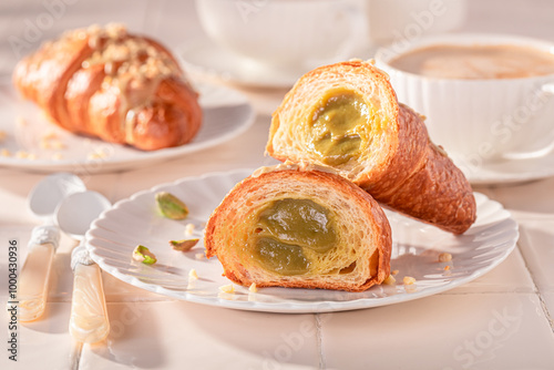 Homemade and hot pistachio croissants served with hot coffee.