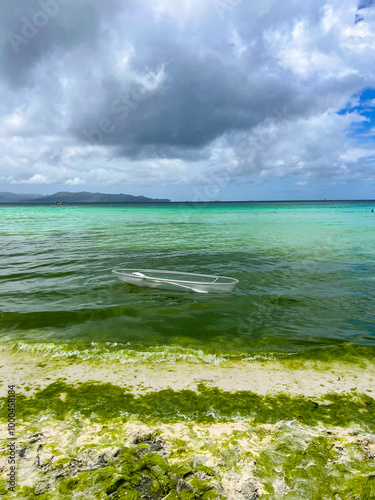 A transparent boat in silty water near the shore in the Philippines  photo