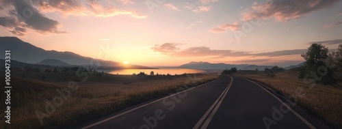 Road leading to horizon with sunset, mountains, lake, and scenic sky in the background.