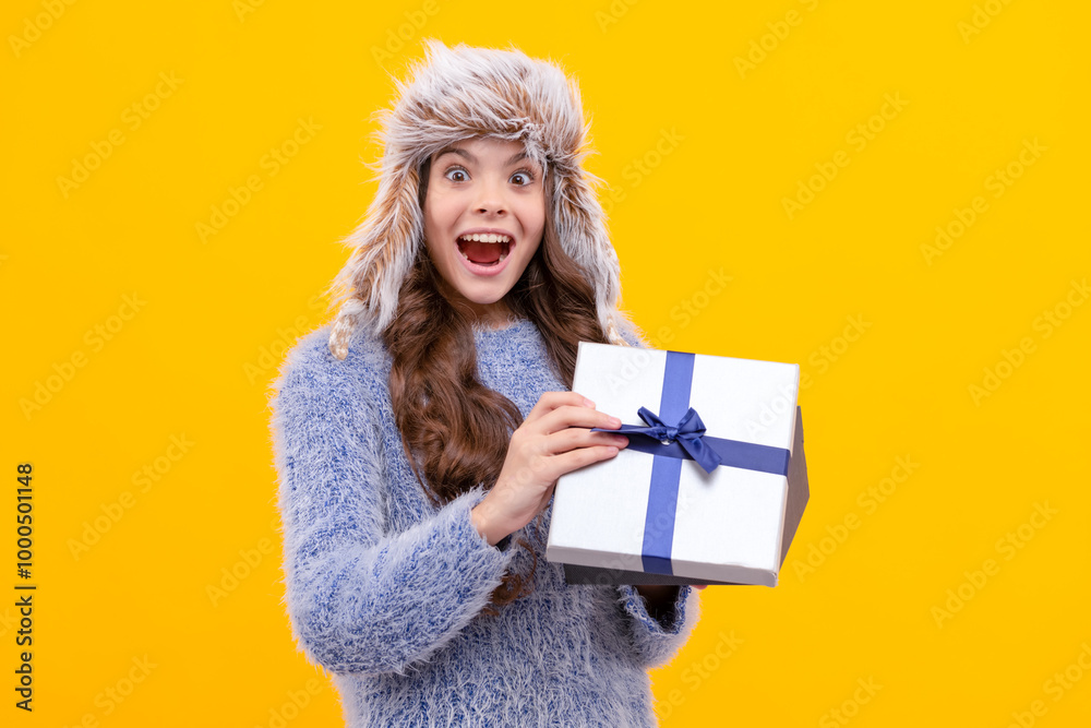boxing day. teen girl in knitwear on yellow background. child buy gift. black friday discount. boxing day. teen girl in knitwear on yellow background. child buy gift. black friday discount.