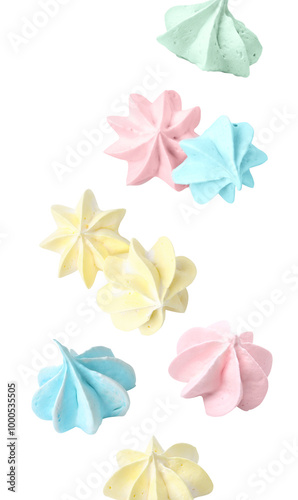 Delicious meringue cookies in air on white background
