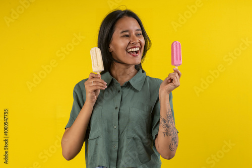 Photography Young woman in studio photo with a strawberry popsicle in her hand