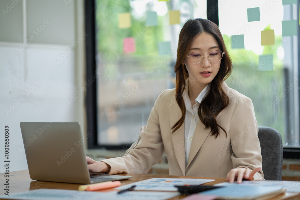 Happy Asian woman working in office Happy Asian woman working in office