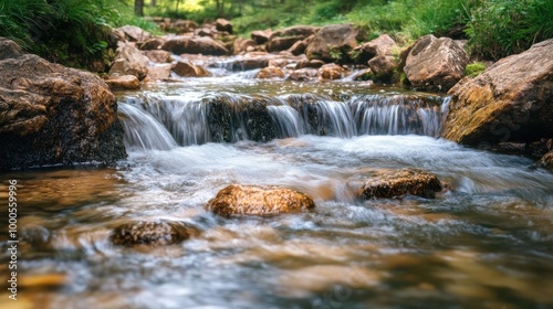 Smooth running water flowing over rocks in a clear mountain stream, creating a peaceful scene -
