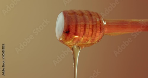 Honey, drip and stick in studio for nutrition, antioxidants and natural sugar. Raw, organic sweetener and drizzling on brown background for healthy food, antibacterial properties and gut health