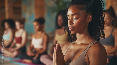 A diverse group of women practicing yoga together in a modern studio, showcasing various poses and demonstrating wellness, fitness, and mindfulness through their synchronized movements.

