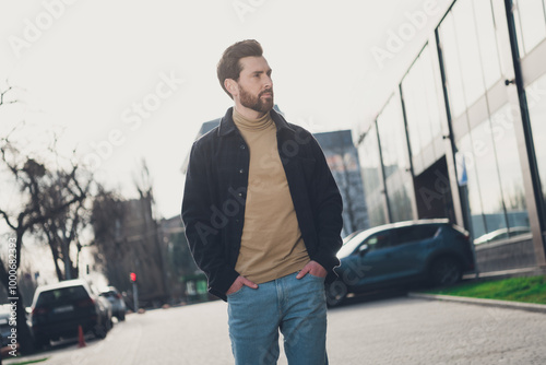 Photo of dreamy young man wear trendy clothes walk explore city outdoors autumn day