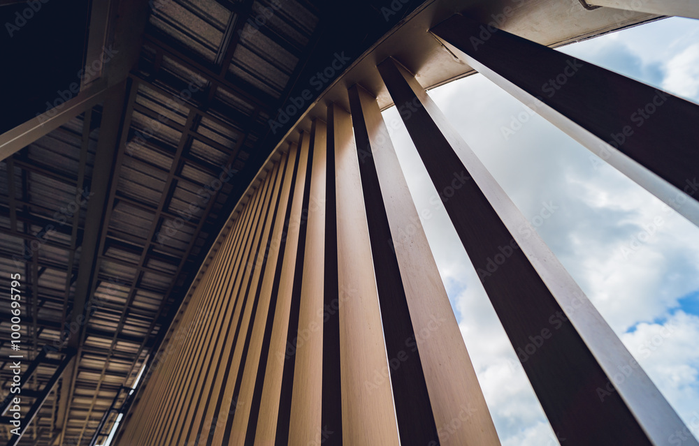A structure featuring wooden slats on construction site contributing to its architectural style A structure featuring wooden slats on construction site contributing to its architectural style