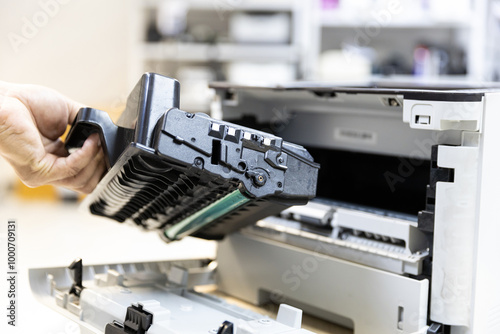 Technician Holding ink printer toner low for replace new or fix repair problem paper or print scanning fax or copy document or photocopier or photocopy office workplace equipment concept photo