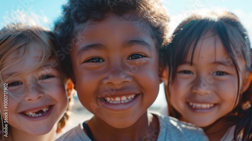 A close-up of three kids from diverse backgrounds, smiling warmly