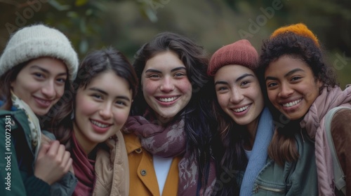 A group of young women from various ethnicities, all smiling and standing closely together