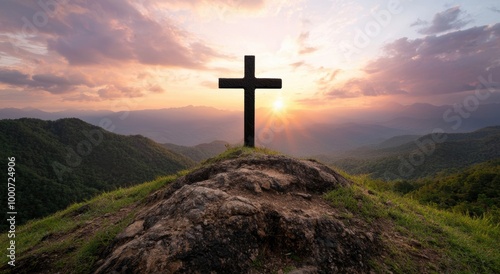 Silhouette of cross on mountain at sunset