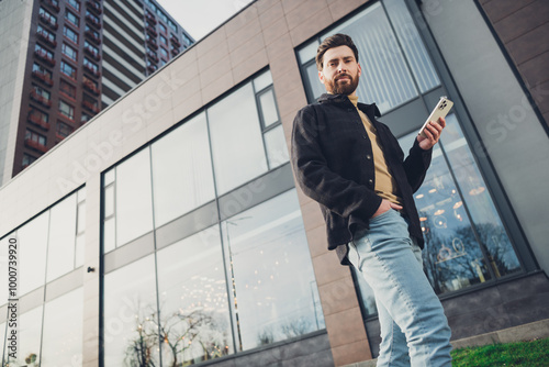 Photo of handsome attractive nice man wear stylish clothes city street autumn day outside enjoy weekend