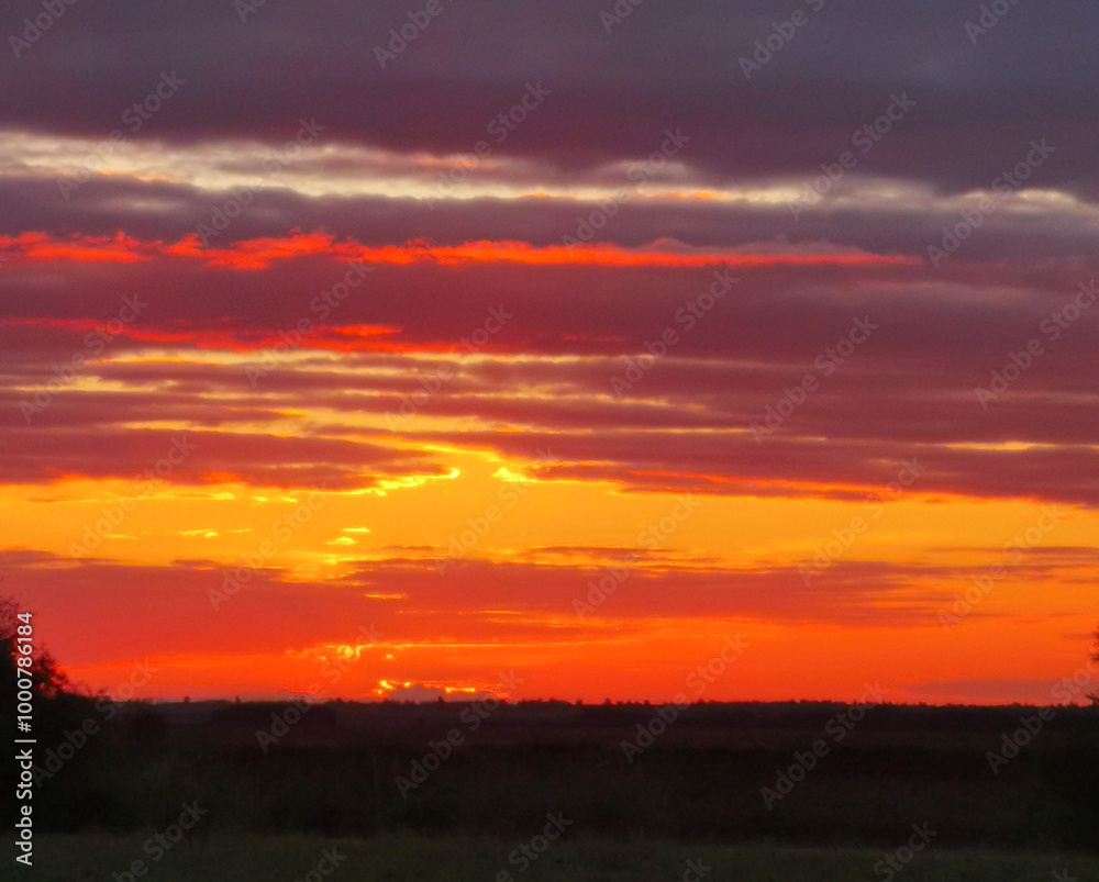 The sky is orange and the sun is setting The sky is orange and the sun is setting
