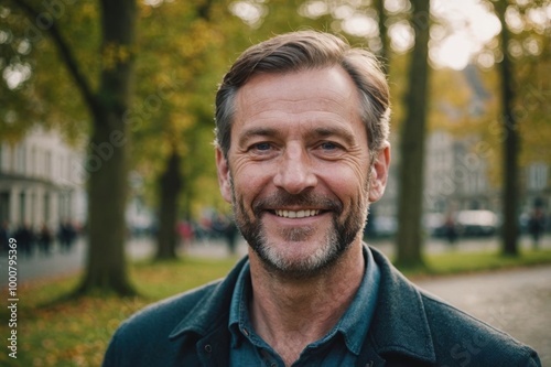 Close portrait of a smiling 40s Irish man looking at the camera, Irish outdoors blurred background