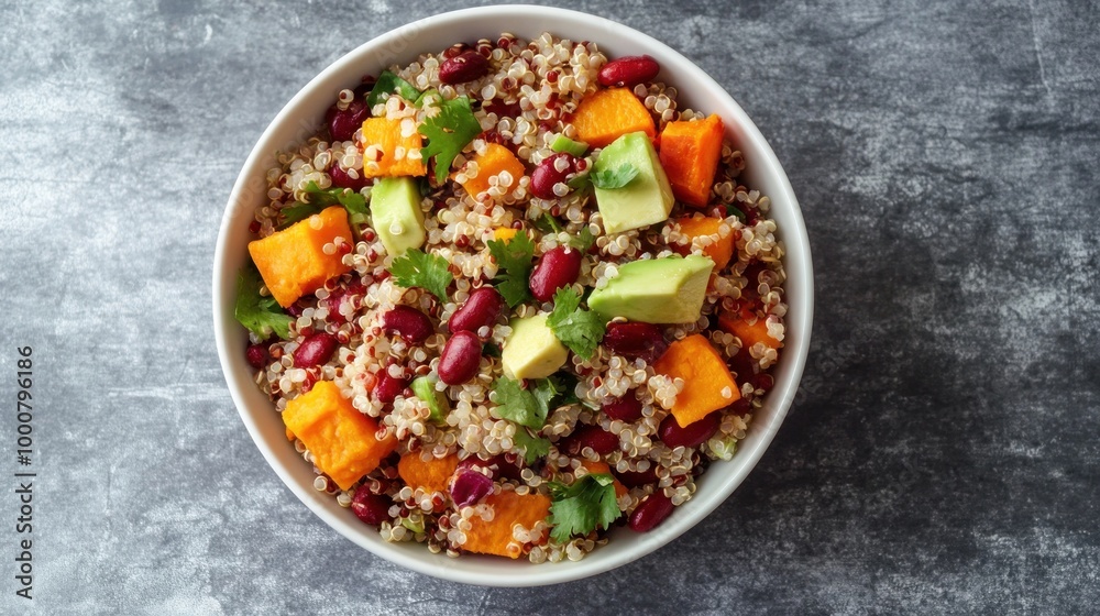On a gray background, quinoa salad with avocado, sweet potato, and beans. superfood idea. Clean, healthful eating philosophy. A gluten-free or vegan diet. upper view.