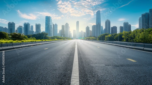 A clear view down a smooth highway leading towards a modern city skyline under bright blue skies, capturing the essence of urban progress and connectivity.