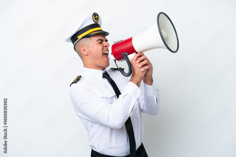 Airplane pilot caucasian man isolated on white background shouting through a megaphone Airplane pilot caucasian man isolated on white background shouting through a megaphone