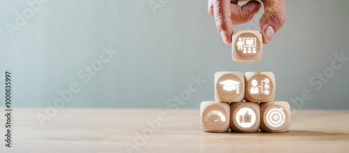 Wooden blocks with icons symbolizing apprenticeship, education, and career growth, illustrating the concept of skill development and learning.